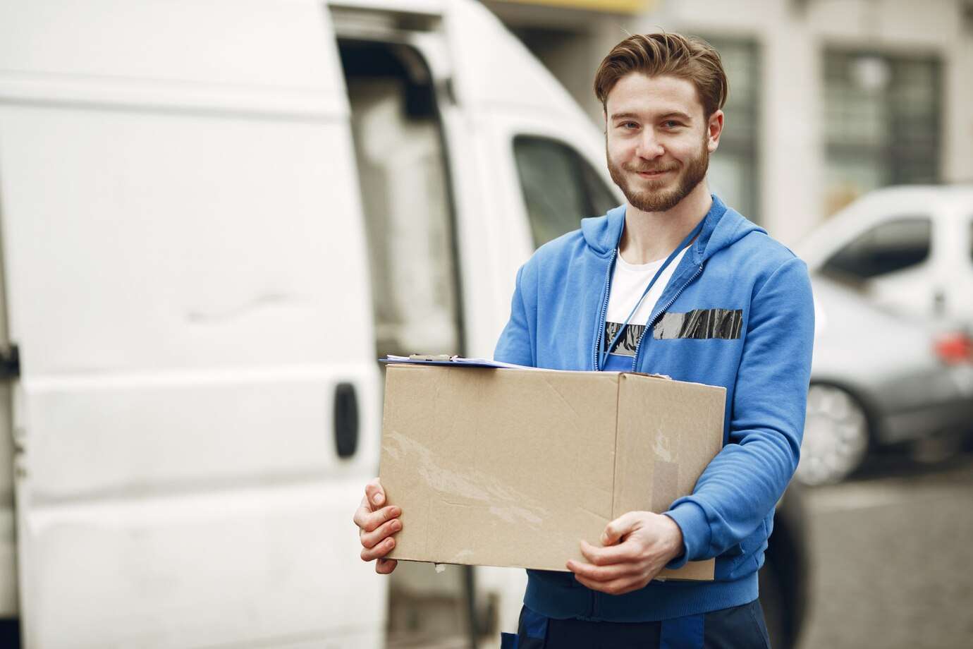 Delivery Guy Smiling And Holding A Box - Delivery Route Optimization