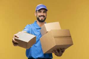 Delivery Guy In Light Blue Passing A Box - Delivery Scheduling Software